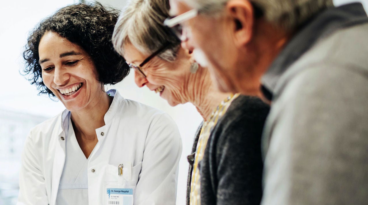 Female doctor discussing options with an elderly couple.